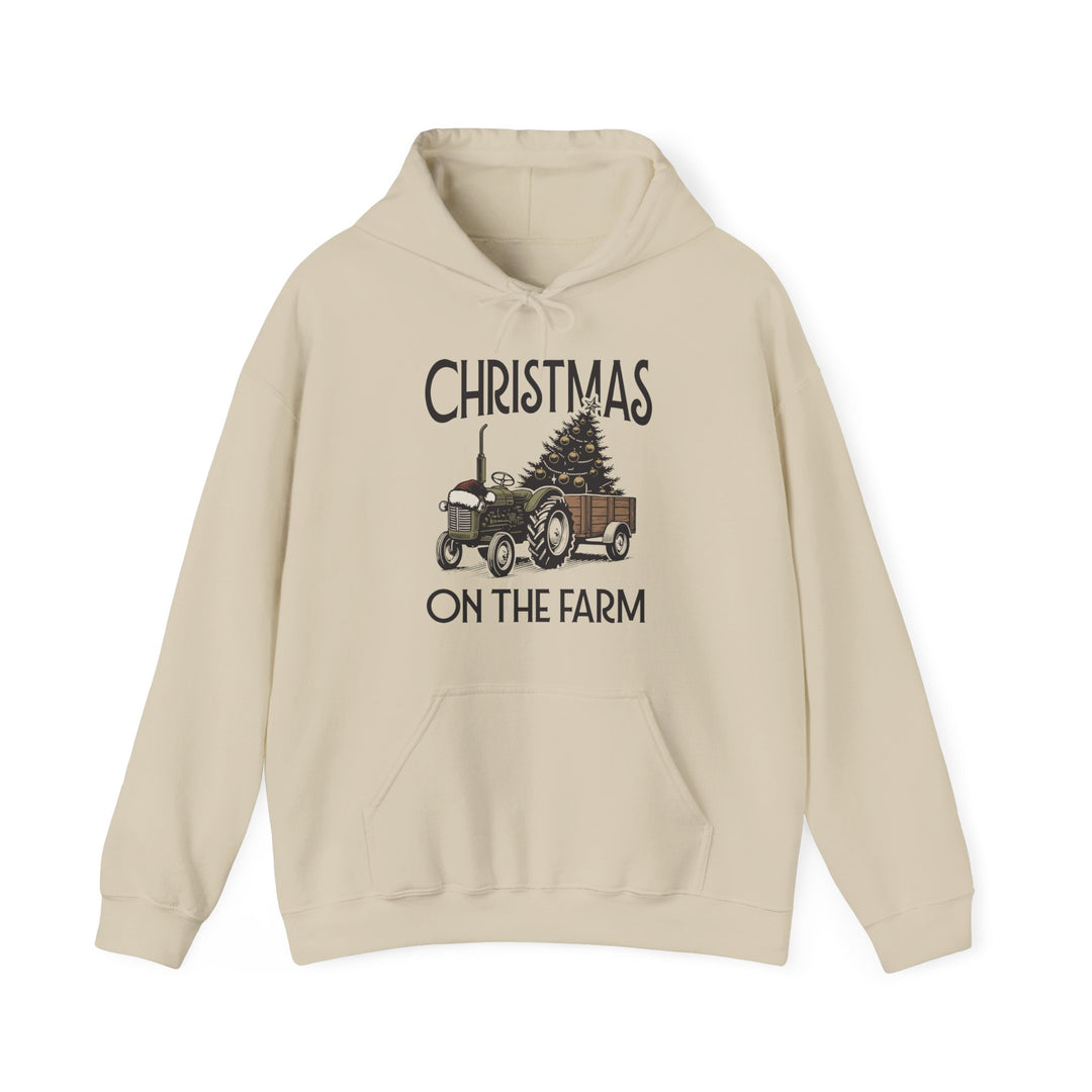 Christmas at the Farm Hoodie featuring a vintage tractor with a Santa hat, pulling a cart with a decorated tree, festive and cozy for winter days.