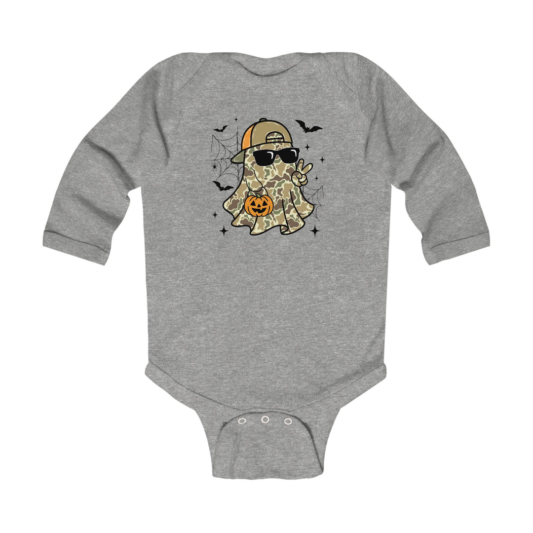 Candy Ghost Long Sleeve Onesie features a camo-patterned ghost graphic with sunglasses and cap, holding a candy bucket, surrounded by bats and spider webs.