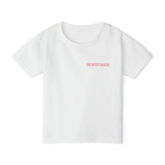 Heavy Cotton™ Toddler T-shirt in white with “HEAVEN MADE” in pink on the chest, offering style and comfort with 100% cotton fabric.