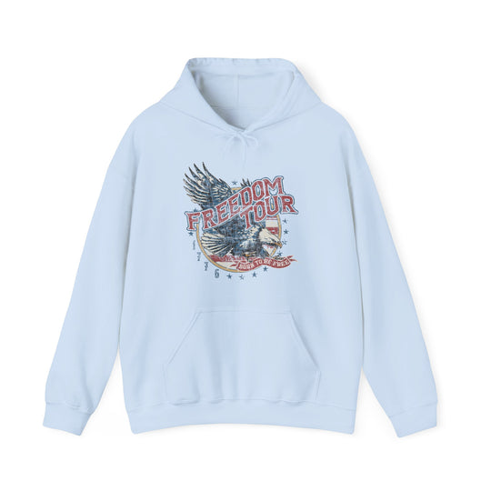 A light blue Freedom Tour Hoodie, a cozy blend of cotton and polyester. Features a kangaroo pocket and drawstring hood, perfect for printing. Unisex, medium-heavy fabric for comfort and warmth.