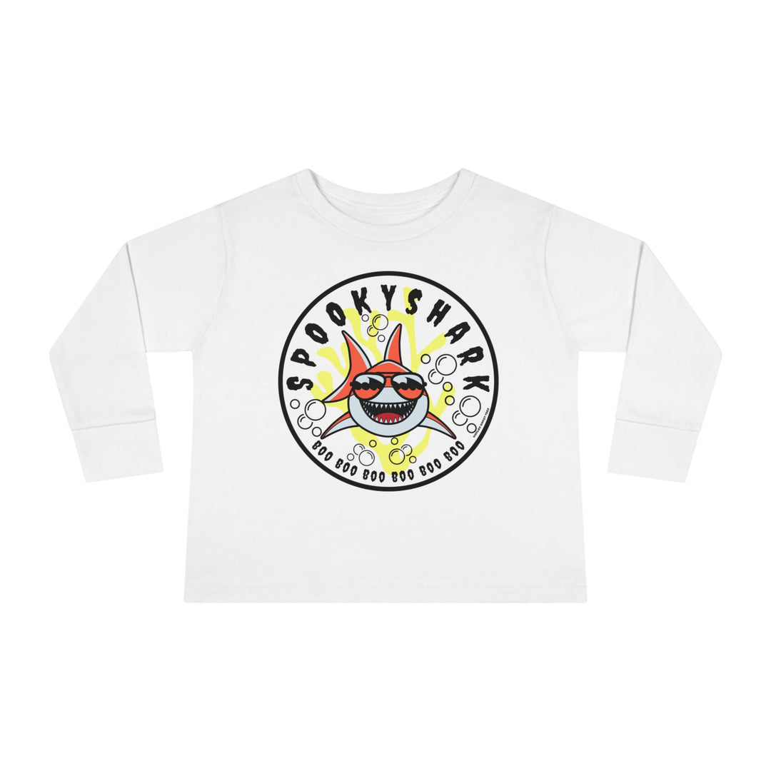 Spooky Shark Toddler Long Sleeve Tee featuring a cartoon shark with sunglasses on a white shirt. Made of 100% combed ringspun cotton, with ribbed collar and EasyTear™ label for comfort and durability.