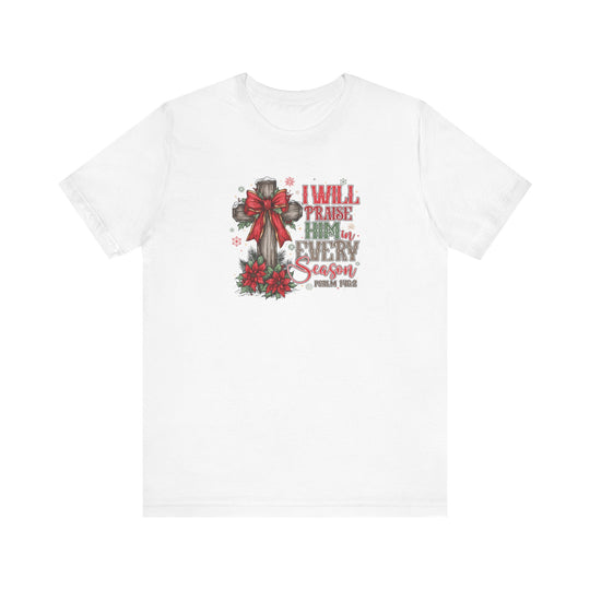 Praise Him in Every Season Tee featuring a wooden cross with a red bow, poinsettias, and snowflakes, accented by Psalm 145:2.