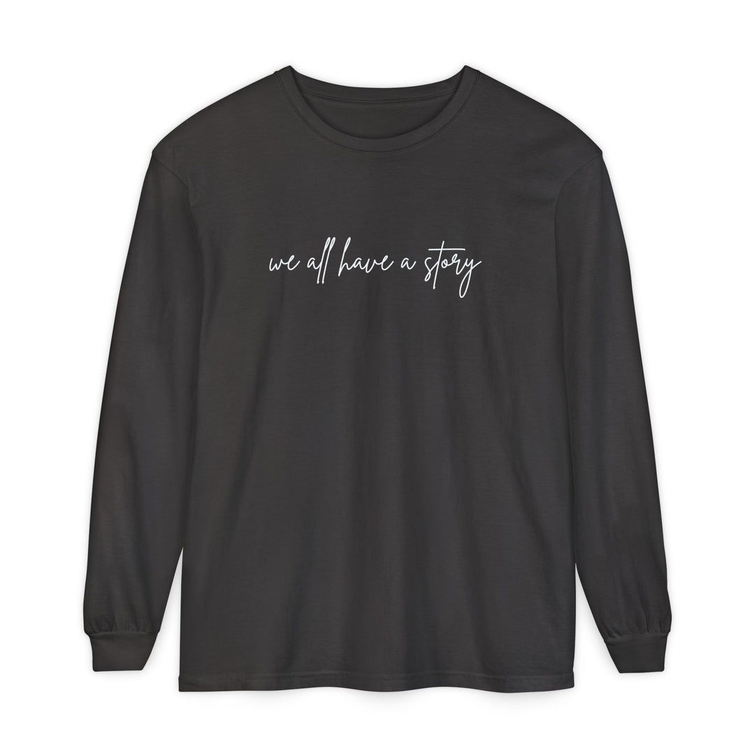We all have a Story Long Sleeve Tee, featuring white text on a black background, crafted from 100% ring-spun cotton for a relaxed fit.