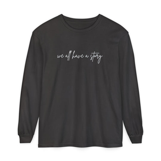 We all have a Story Long Sleeve Tee, featuring white text on a black background, crafted from 100% ring-spun cotton for a relaxed fit.