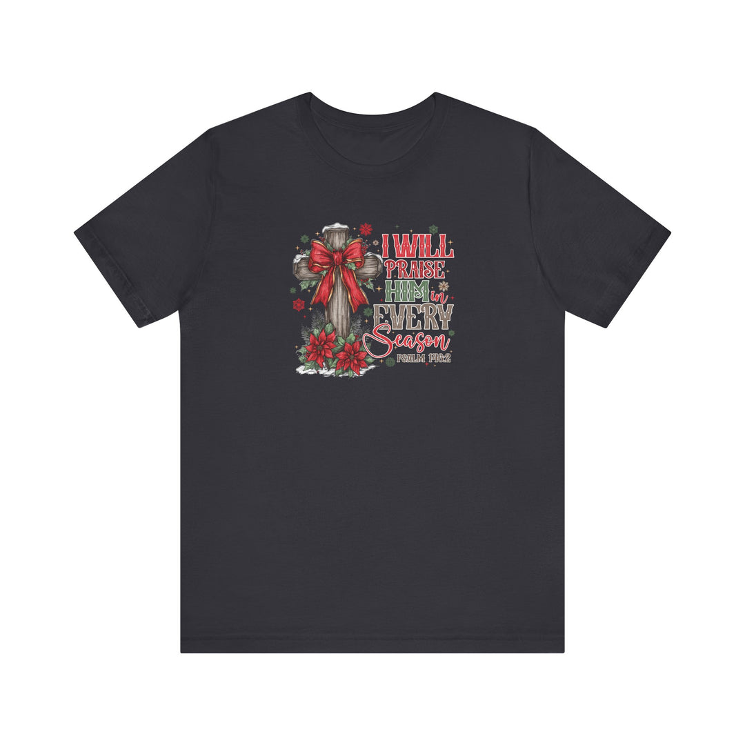 Black T-shirt with festive graphic: wooden cross with red bow, poinsettias, and snowflakes, featuring I WILL PRAISE HIM in EVERY season and Psalm 146:2 text.