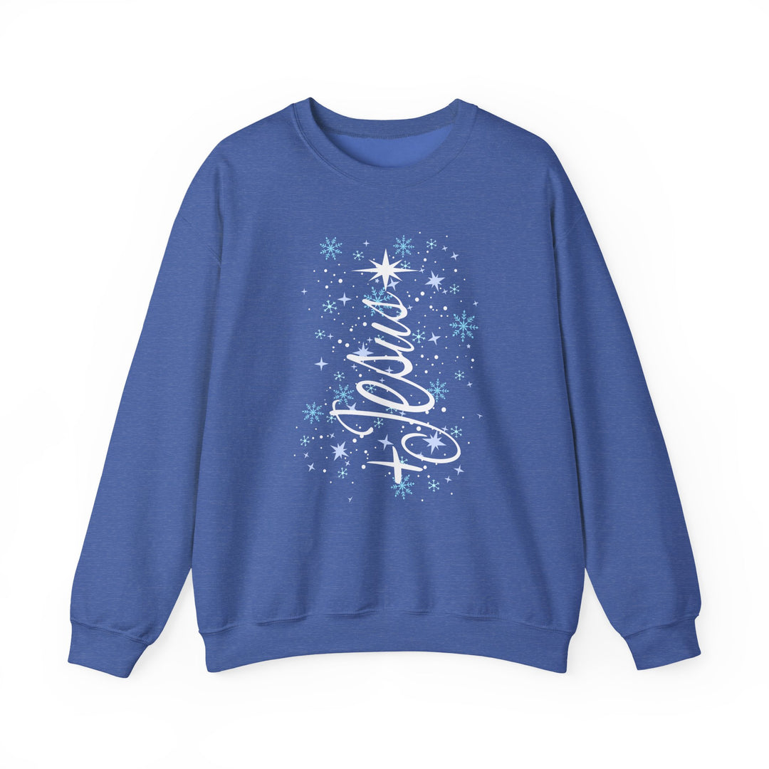Blue crew-neck sweatshirt with Believe in cursive, adorned with stars and snowflakes, embodying festive spirit. Durable, cozy blend for cold weather. Jesus Tree Crew design.