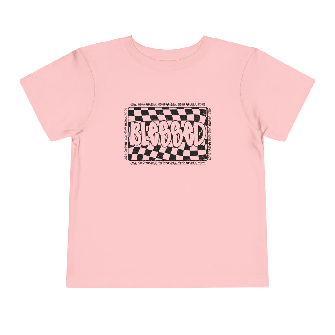 Blessed Toddler Tee, a pink short sleeve t-shirt with black and white checkered design, made from soft cotton for comfort. Ideal for adding style to toddlers' daily wear.