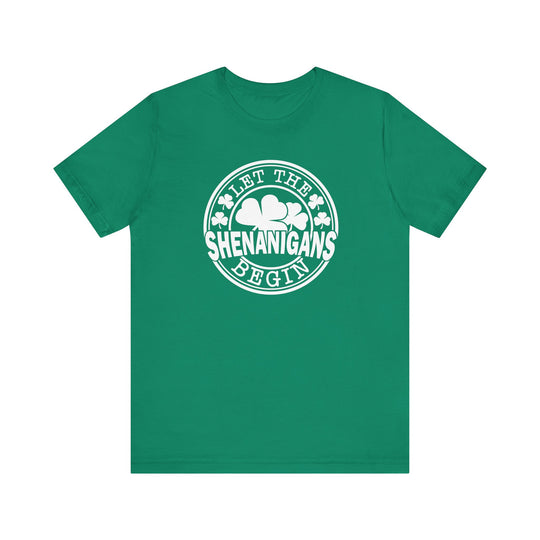 Let The Shenanigans Begin Tee: A green short sleeve t-shirt with white text, featuring a comfortable retail fit and ribbed knit collars.