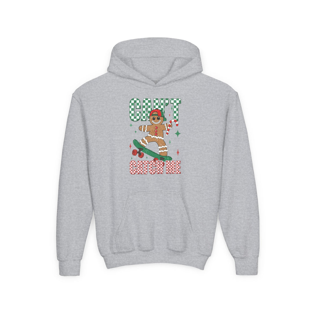 Can't Catch Me Youth Hoodie featuring a skateboard-riding gingerbread man with a candy cane, vibrant CAN'T CATCH ME text, and a cozy kangaroo pocket.