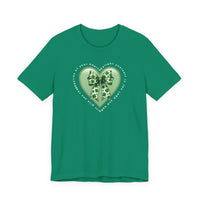 Delight in the LORD Tee featuring a pale-green heart with shamrock bow and inspirational text, laid flat to showcase its soft, quality cotton fabric.