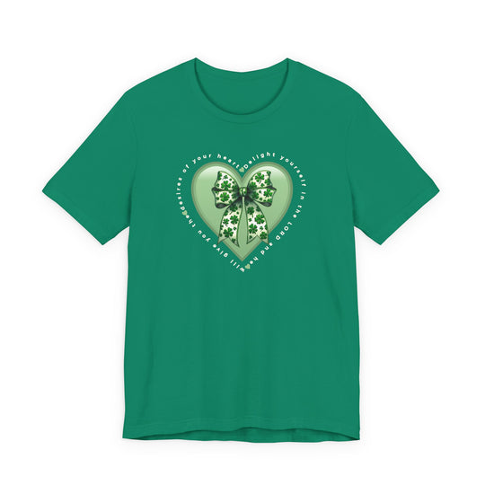 Delight in the LORD Tee featuring a pale-green heart with shamrock bow and inspirational text, laid flat to showcase its soft, quality cotton fabric.
