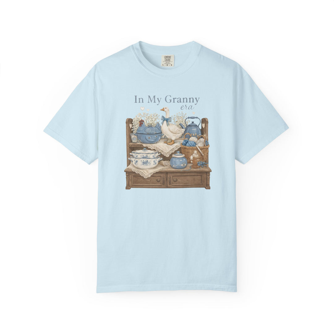 In My Granny Era Tee featuring a cozy vintage still life with ceramic goose, porcelain tureen, and yarn basket, evoking nostalgic charm.