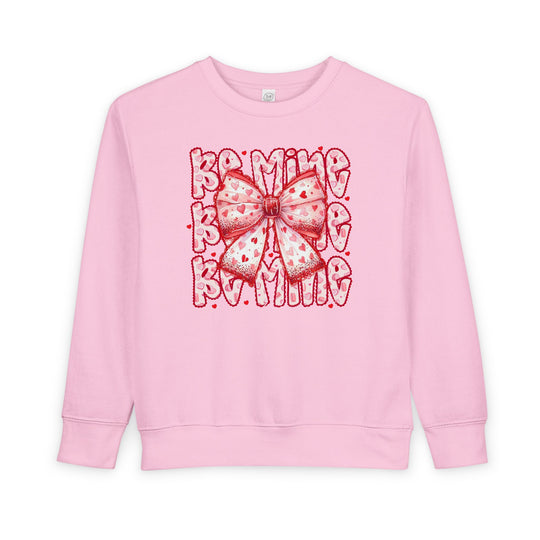 Be Mine Toddler Crew sweatshirt with heart-patterned bow graphic and BE MINE text, designed for warmth and durability in a soft cotton-polyester blend.