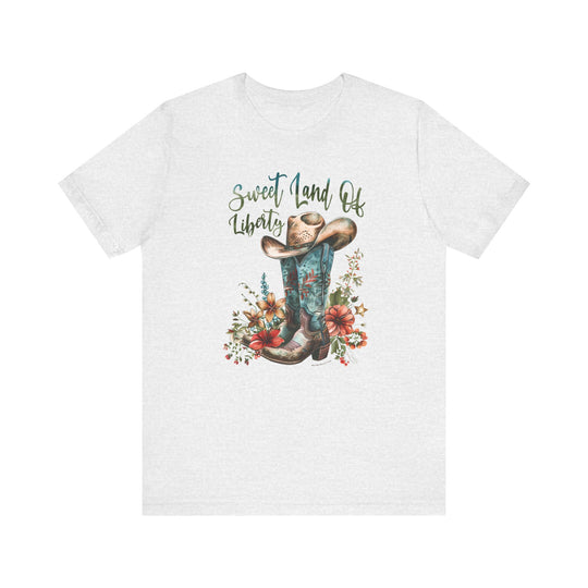 A white t-shirt featuring a cowboy hat and flowers, embodying a classic Americana vibe. Made of 100% Airlume combed cotton, with ribbed knit collars and taping on shoulders for lasting comfort and fit.