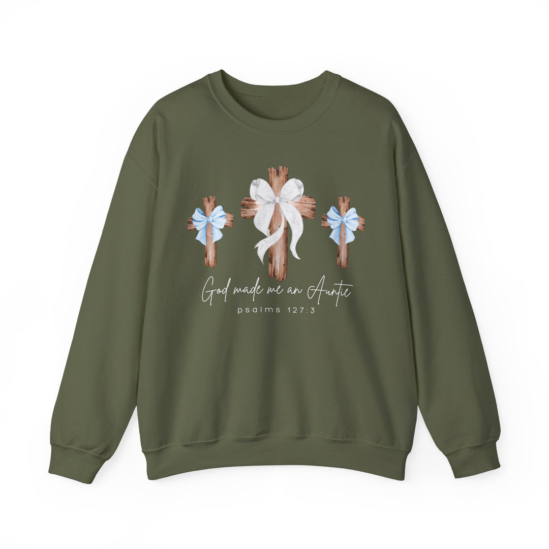 Olive-green crewneck sweatshirt featuring three wooden crosses with bows, slogan God made me an Auntie, and psalms 127:3 reference. Unisex, cotton-polyester blend.