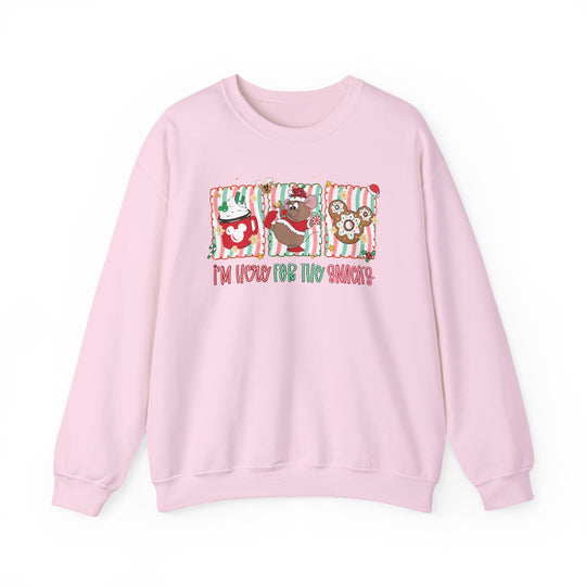 Light-pink crewneck sweatshirt featuring festive snack-themed graphics and I'm here for the snacks text, ideal for cozy, casual wear.