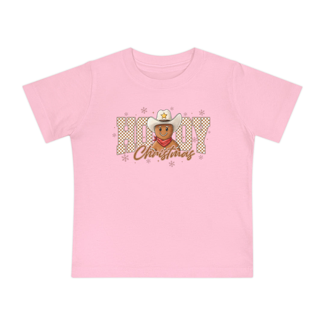 Howdy Christmas Baby Tee: Light pink children's T-shirt featuring a festive gingerbread cowboy with HOWDY and Christmas text, snowflakes, and a durable, soft cotton fabric.