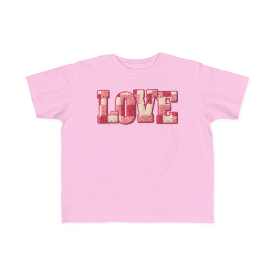 Light-pink toddler tee with “LOVE” in textured chenille letters, offering softness for sensitive skin. Ideal for first adventures.