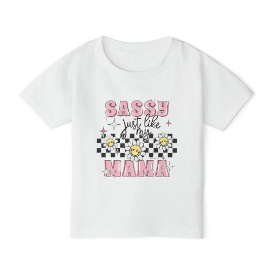 Toddler tee with pink and black text, floral accents, and a smiley face. Made of 100% cotton for softness and comfort. Classic fit with rib collar. Sassy Just Like My Mama Toddler Tee.