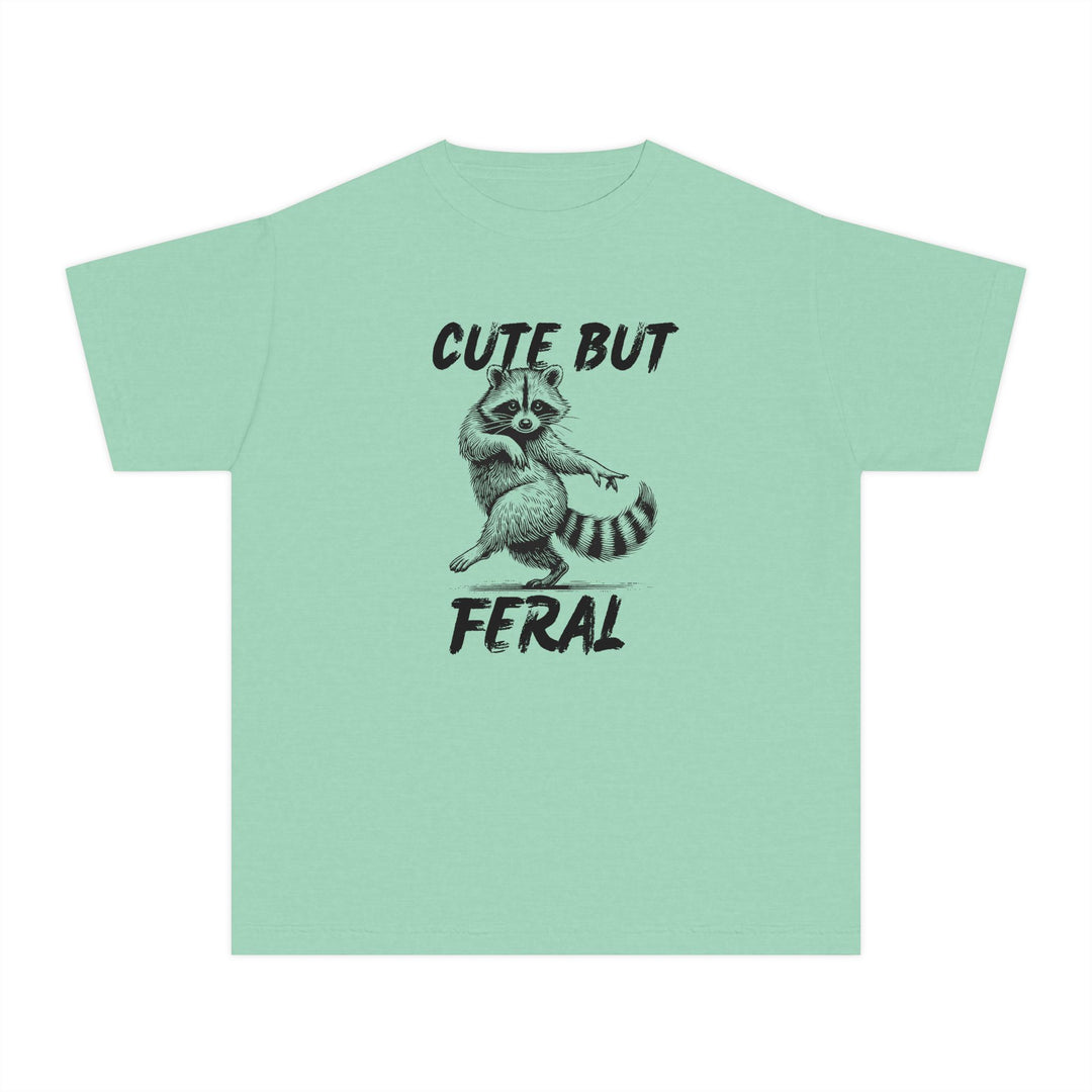 Cute but Feral Kids Tee with a playful raccoon sketch and slogan, designed for comfort and agility in 100% combed cotton, perfect for active kids.