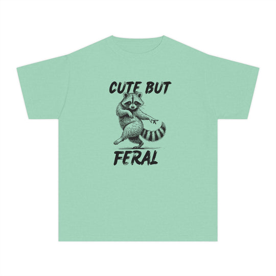 Cute but Feral Kids Tee with a playful raccoon sketch and slogan, designed for comfort and agility in 100% combed cotton, perfect for active kids.