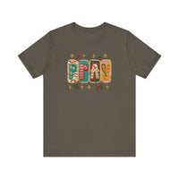 Pray Tee: Olive-green crew-neck displaying PRAY in festive knit-style graphics with holiday motifs. Cozy, unisex fit, crafted from soft cotton.