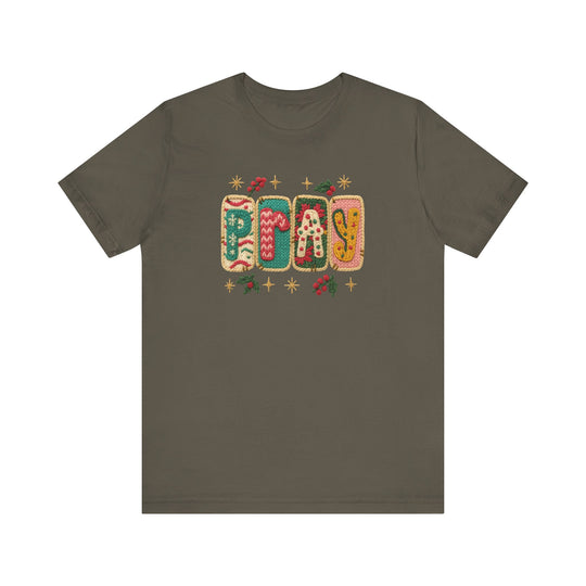 Pray Tee: Olive-green crew-neck displaying PRAY in festive knit-style graphics with holiday motifs. Cozy, unisex fit, crafted from soft cotton.