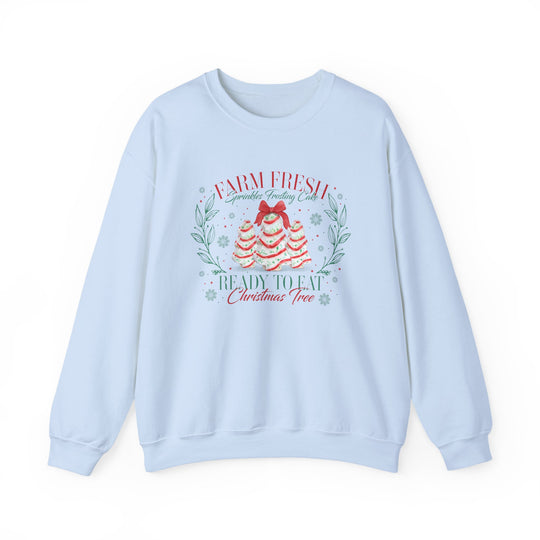 Light-blue crewneck sweatshirt displaying festive cake trees with Farm Fresh Sprinkles Frosting Cake text, blending comfort and holiday spirit from Faith Family Designs.