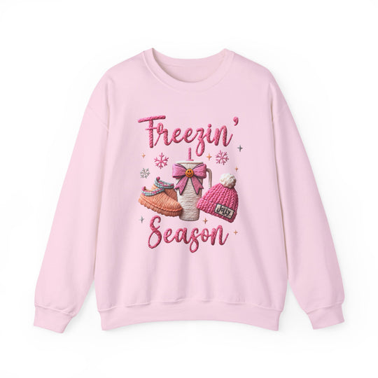 Freezin Season Crew sweatshirt featuring winter motifs: slippers, mug, Jolly beanie, snowflakes; ribbed collar, no side seams, polyester-cotton blend for comfort.