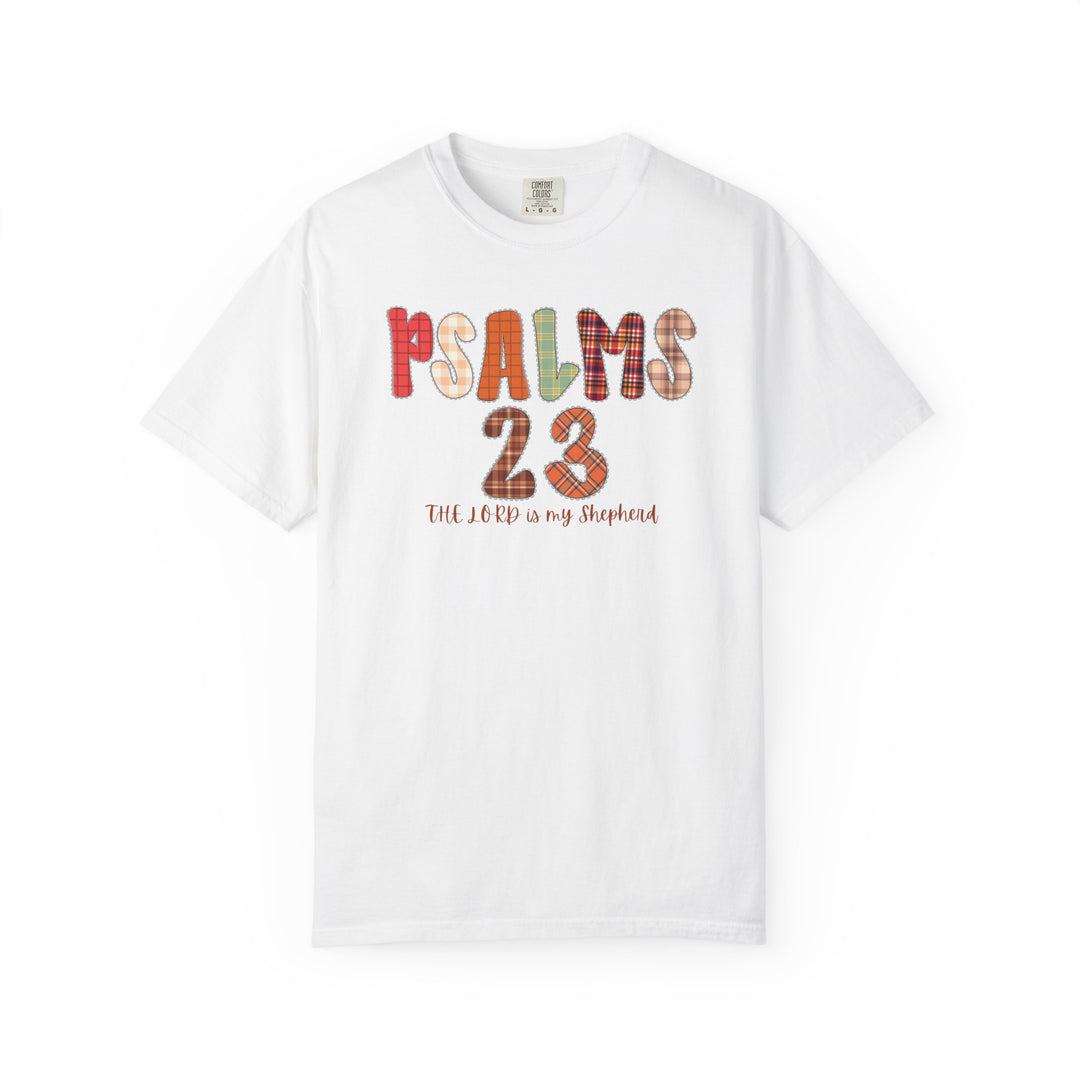 White Comfort Colors T-shirt displaying PSALMS 23 in patchwork plaid patterns with THE LORD is my Shepherd below, capturing Faith Family Designs' unique graphic style.