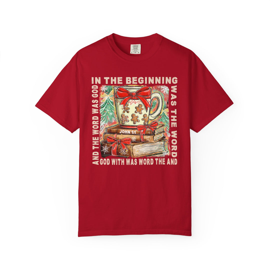 In the Beginning Tee: Red T-shirt featuring a Christmas mug, gingerbread cookies, books, and John 1:1 Bible verse, offering cozy, stylish comfort.