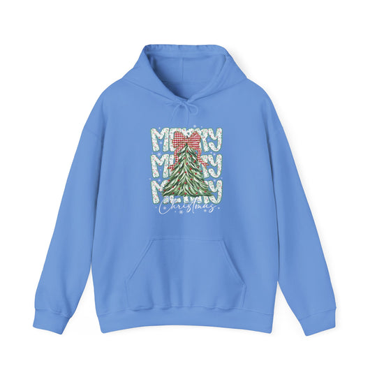 Light-blue hoodie featuring a festive Christmas tree graphic, MERRY text, and Christmas script, with kangaroo pocket and drawstring hood for cozy wear.