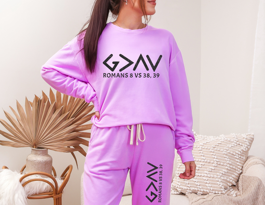 Woman in sweatpants from the God is Greater Sweatpants collection, showcasing relaxed fit and retro style made from American-sourced ringspun cotton.