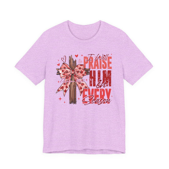 Praise in Every Season Heart Tee with a rustic wooden cross and heart-patterned bow, featuring “Psalm 146:2” and bold red lettering.