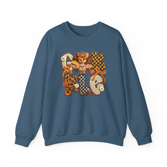 Blue crew-neck sweatshirt featuring GOBBLE in crochet-style autumnal patterns with a cartoon turkey on the O, ideal for fall/Thanksgiving wear.