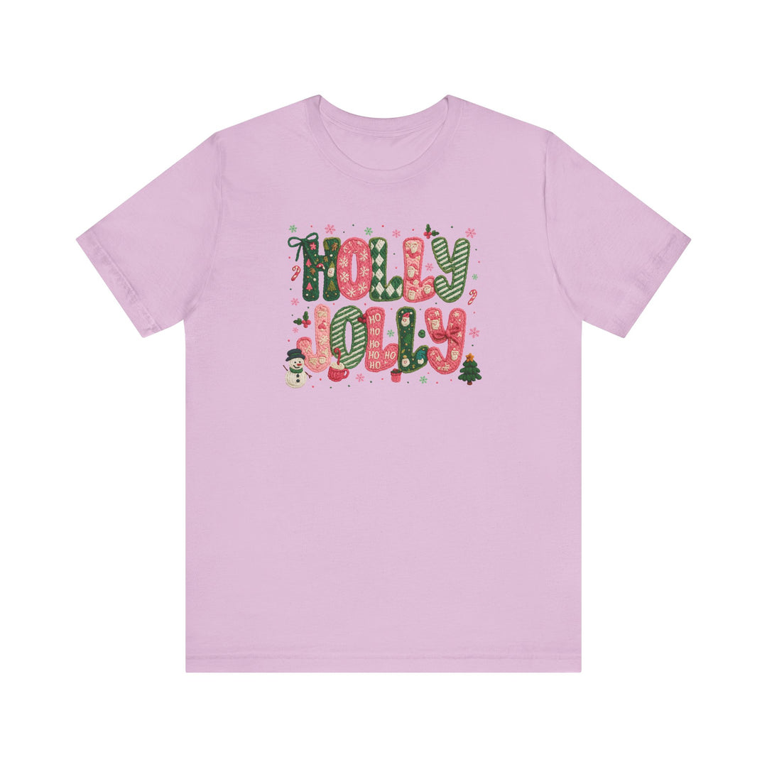 Light pink Holly Jolly Tee with festive lettering and holiday icons, crafted from soft cotton for comfort and durability. Unisex fit, available in multiple sizes.