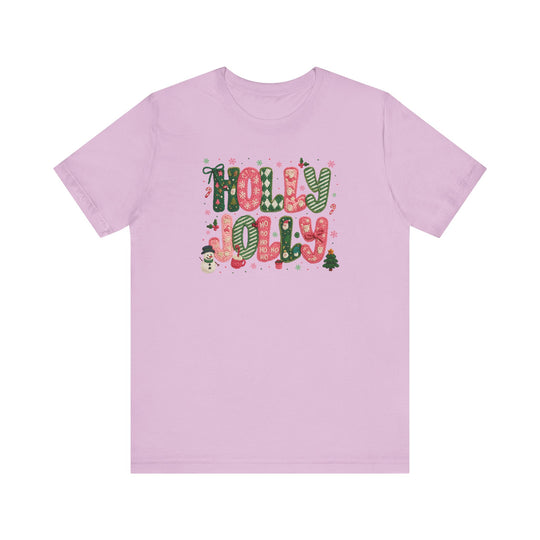 Light pink Holly Jolly Tee with festive lettering and holiday icons, crafted from soft cotton for comfort and durability. Unisex fit, available in multiple sizes.