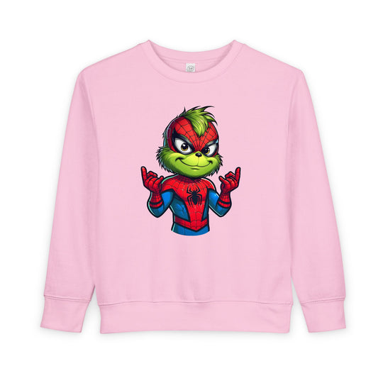 Light pink toddler sweatshirt with a Grinch-like character in a Spider-Man suit, web-shooting gesture, showcasing Faith Family Designs' playful style.