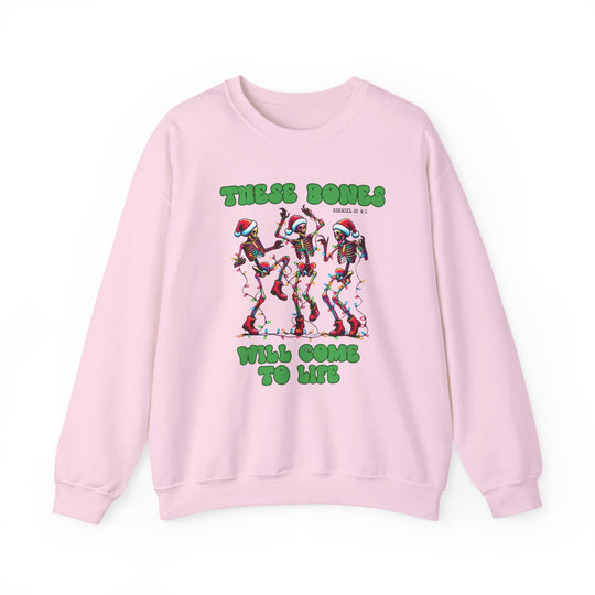 Bones Come to Life Crew sweatshirt featuring dancing skeletons in Santa hats with Christmas lights, Ezekiel 37:4-5 reference, on light-pink fabric.