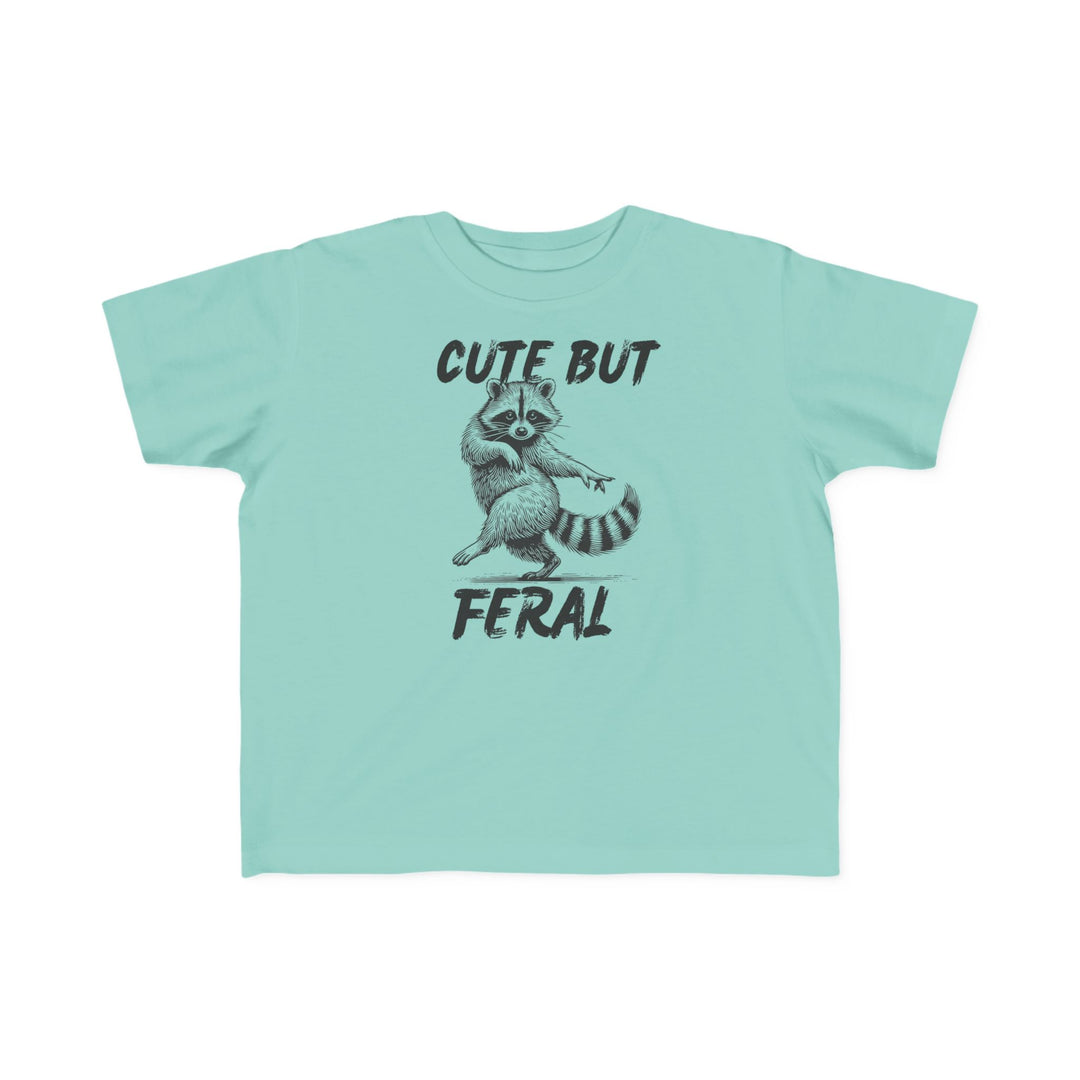 Cute but Feral Toddler Tee featuring a playful raccoon graphic and brushstroke text, perfect for toddlers with its soft, durable cotton fabric and classic fit.