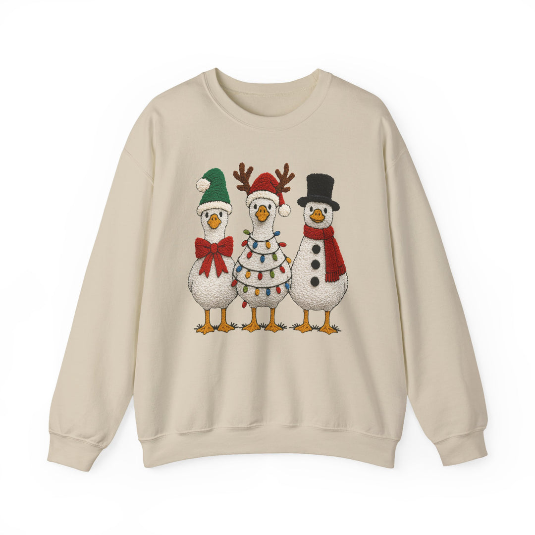 Light-beige crewneck sweatshirt with three Christmas-themed geese, featuring a Santa hat, reindeer antlers, and snowman attire, from Faith Family Designs' Christmas Ducks Crew collection.
