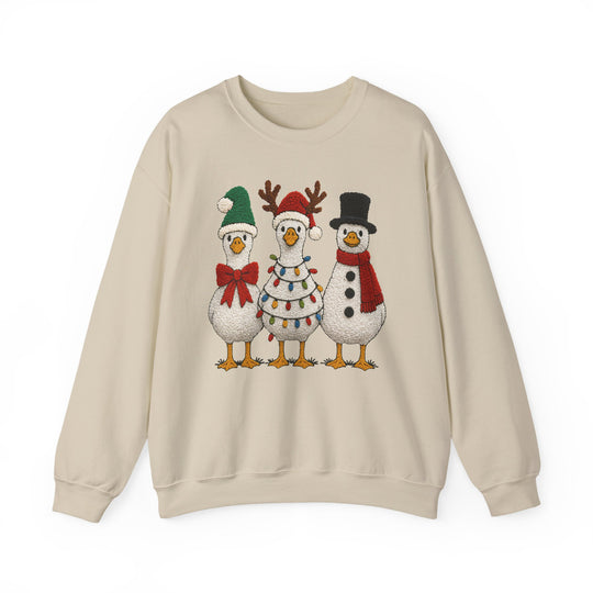 Light-beige crewneck sweatshirt with three Christmas-themed geese, featuring a Santa hat, reindeer antlers, and snowman attire, from Faith Family Designs' Christmas Ducks Crew collection.