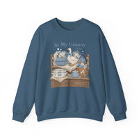 In My Granny Era Crew: A slate-blue sweatshirt featuring a vintage-style illustration of a tiered shelf with ceramic and knit items, hearts, and text.