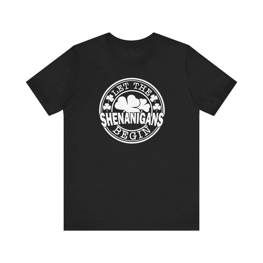 Let The Shenanigans Begin Tee, a black t-shirt featuring white text and clovers, offering a soft, retail fit with ribbed collars and taping for durability.
