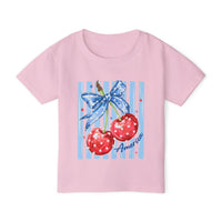 American Cherry Toddler Tee features a patriotic cherry design with stars, blue ribbon, and America text, crafted from soft, eco-friendly cotton for comfort.