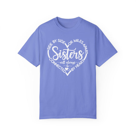 Sisters At Heart Tee: Blue t-shirt featuring white text, made with 100% ring-spun cotton, offering a relaxed fit and durable double-needle stitching.