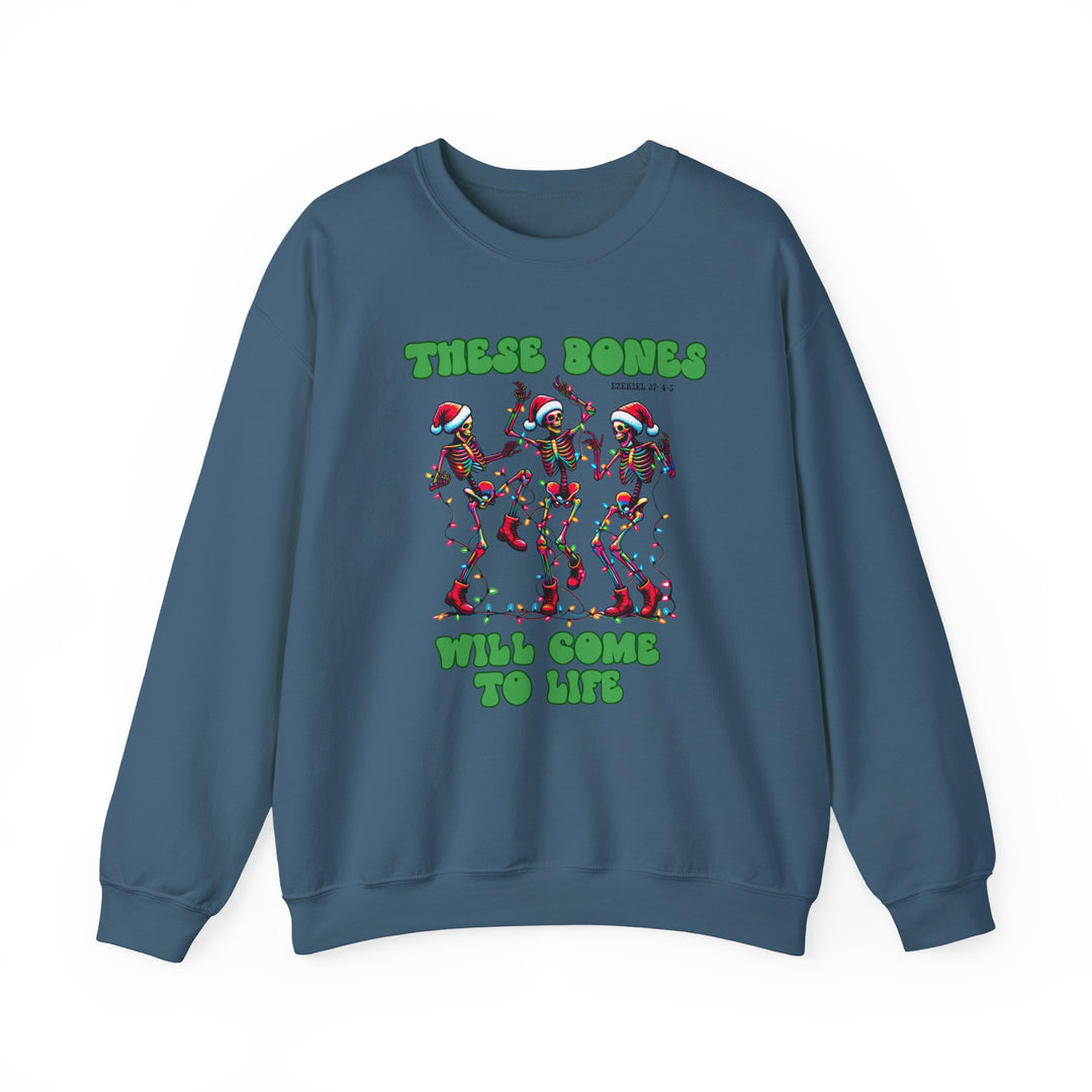 Slate-blue crewneck sweatshirt with dancing skeletons in Santa hats, tangled in Christmas lights, featuring THESE BONES WILL COME TO LIFE text. Cozy, durable, holiday-themed.