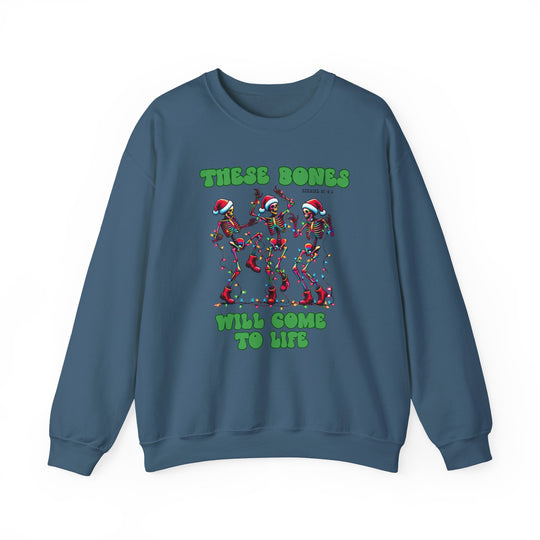 Slate-blue crewneck sweatshirt with dancing skeletons in Santa hats, tangled in Christmas lights, featuring THESE BONES WILL COME TO LIFE text. Cozy, durable, holiday-themed.