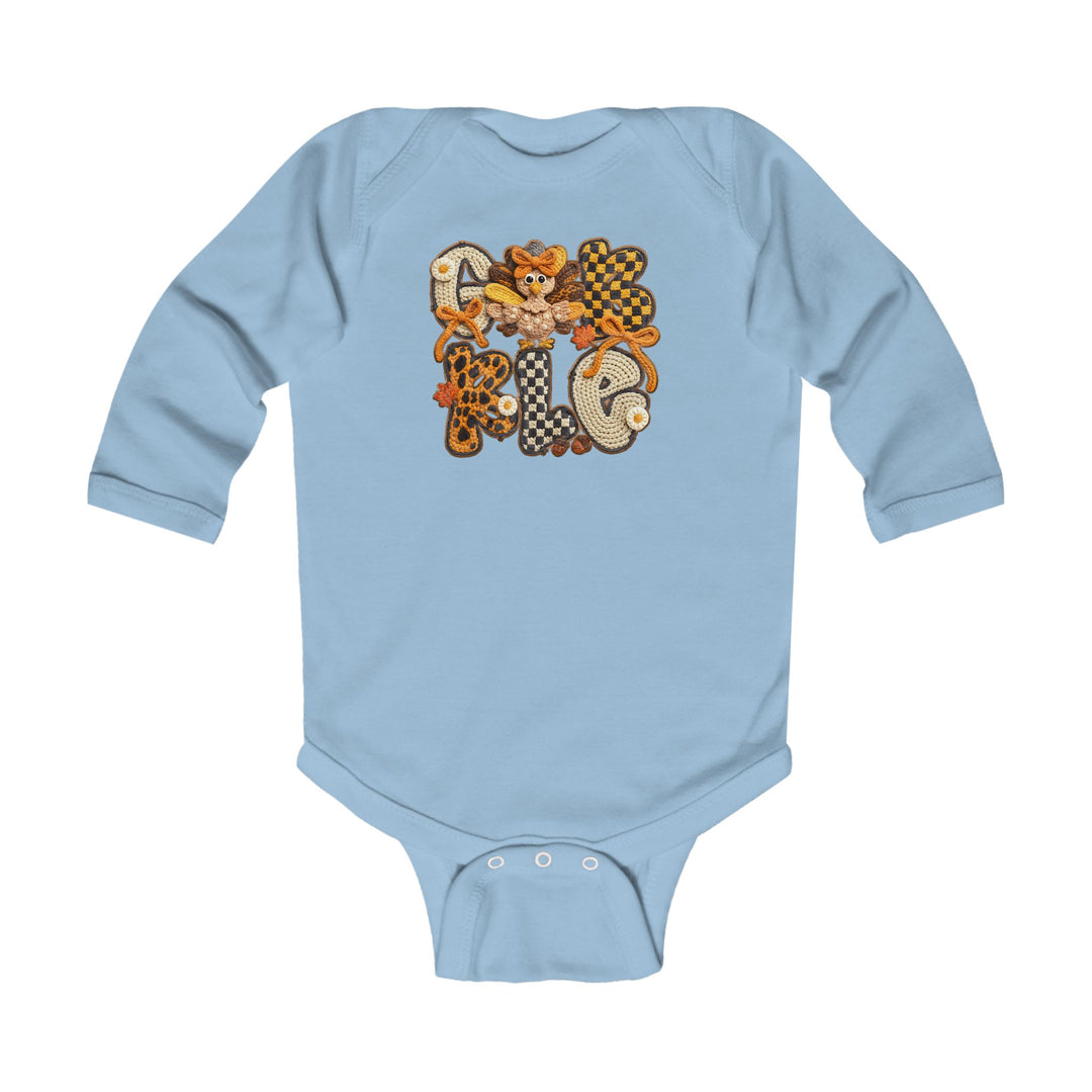 Gobble Onesie: Light-blue long-sleeve infant bodysuit with GOBBLE applique, featuring a turkey graphic. Durable cotton fabric with plastic snaps for easy changing.