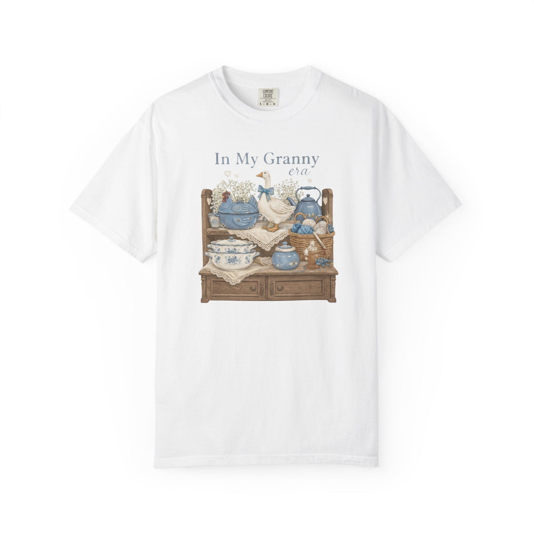 “In My Granny Era Tee” features vintage-style decor graphic on white short-sleeve, offering a cozy, durable fit with 100% ring-spun cotton.